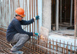 Construction worker cutting steel rods
