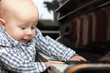beautiful little baby boy plays piano