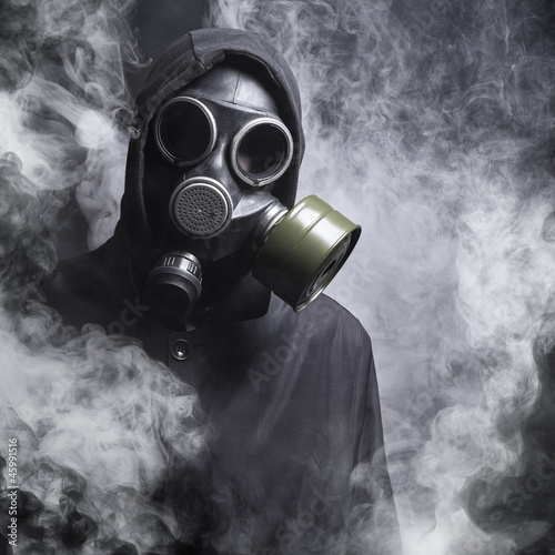 Photo: A man in a gas mask in the smoke A man in a gas mask in the smoke