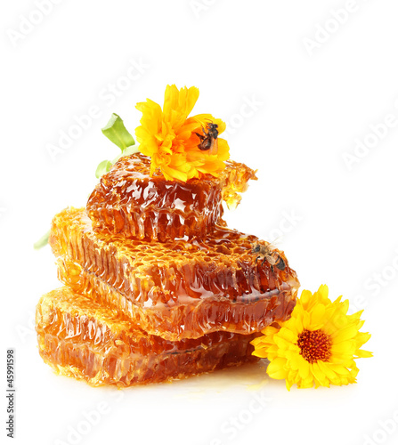 Photo: sweet honeycomb with honey, bee and flowers, isolated on white sweet honeycomb with honey, bee and flowers, isolated on white