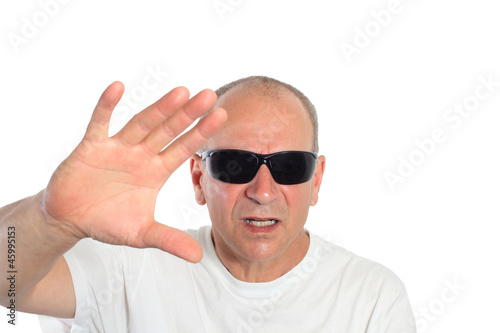 Photo: man with sunglasses making a sign man with sunglasses making a sign