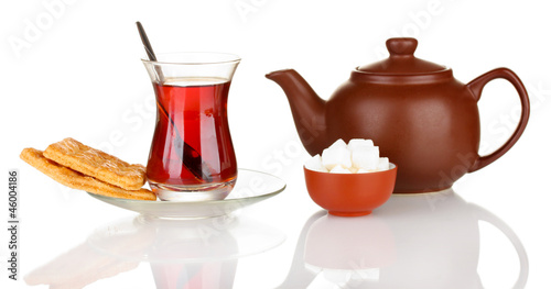 Photo: glass of Turkish tea and kettle isolated on white glass of Turkish tea and kettle isolated on white