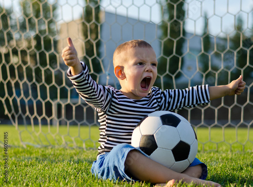 Photo: Boy with football shouting with glee Boy with football shouting with glee