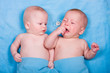 Two babies - one looking, one crying