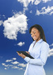 Happy woman with tablet computer and clouds