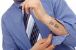 Body part of businessman with tattoo in forearm