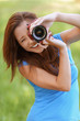 young woman smiles and photographs