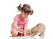 painting child girl with playful kitten