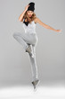 Female modern dancer posing on grey