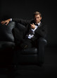 Photo: Handsome man in a tuxedo on couch Handsome man in a tuxedo on couch