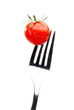 Foto: Close up of red tomato on the fork, isolated on white Close up of red tomato on the fork, isolated on white