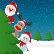 santa reindeer and snowman behind tree