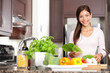 Photo: Woman cooking in new kitchen Woman cooking in new kitchen