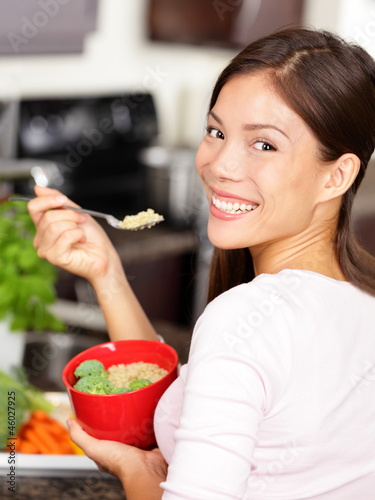 Photo: woman eating quinoa salad woman eating quinoa salad