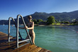 Woman relaxing on the stairs to water II