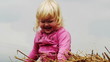 little girl indulges in a haystack
