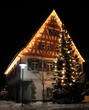 Foto: X-ms tree in front of an old german house X-ms tree in front of an old german house