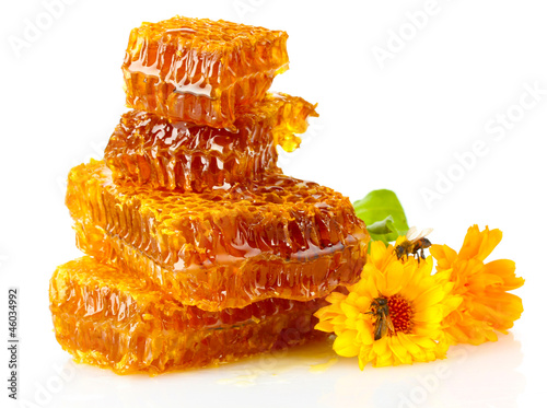 Photo: sweet honeycomb with honey, bee and flowers, isolated on white sweet honeycomb with honey, bee and flowers, isolated on white