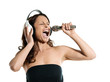 Photo: Portrait of a beautiful woman singing into microphone with headp Portrait of a beautiful woman singing into microphone with headp