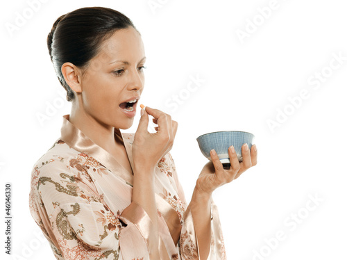 Photo: Portrait of beautiful Asian woman taking pill Portrait of beautiful Asian woman taking pill