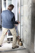 Handyman fitting new windows to house