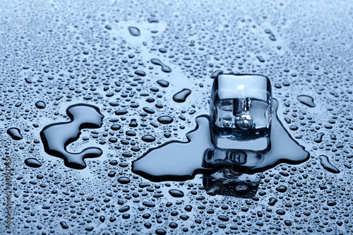 Photo: Ice cube over dark background Ice cube over dark background