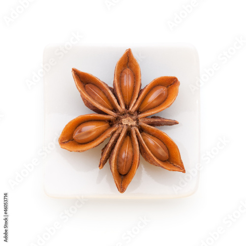 Photo: Anise star (Illicium verum) in a white bowl on white background Anise star (Illicium verum) in a white bowl on white background