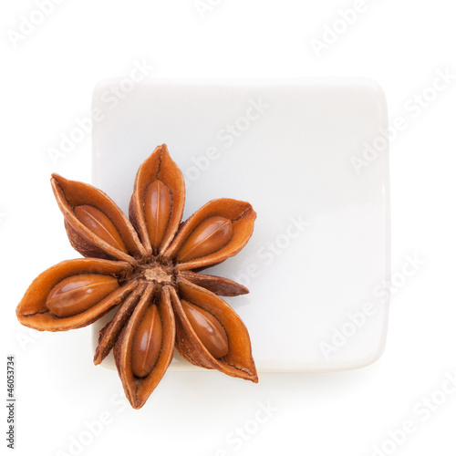 Photo: Anise star (Illicium verum) in a white bowl on white background Anise star (Illicium verum) in a white bowl on white background