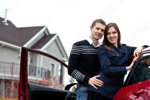 Photo: young successful family near the car young successful family near the car