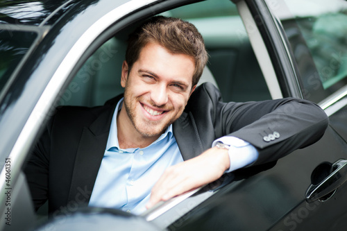 Photo: Young man sitting in a car Young man sitting in a car