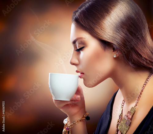 Photo: Beautiful Girl Drinking Tea or Coffee Beautiful Girl Drinking Tea or Coffee