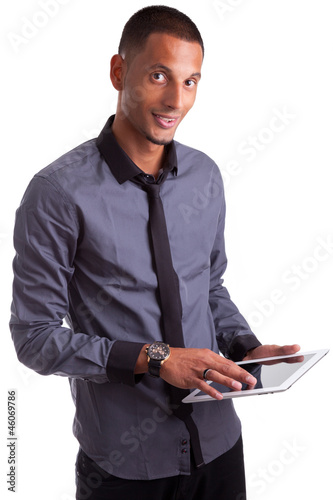 Photo: Young african american man using a tablet pc Young african american man using a tablet pc