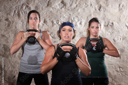 Photo: Ladies Lifting Kettlebells in Boot Camp Style Workout Ladies Lifting Kettlebells in Boot Camp Style Workout