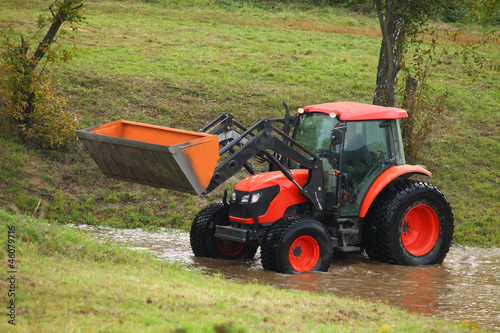 Photo: Tractor repair of rural roads, which flooded the rain Tractor repair of rural roads, which flooded the rain