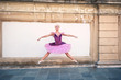 Young beautiful ballerina jumping in Bologna - Pincio, Italy. Ba