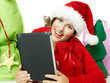 Miss Santa shopping on the internet with touchpad for Christmas