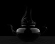 Teapot on black background