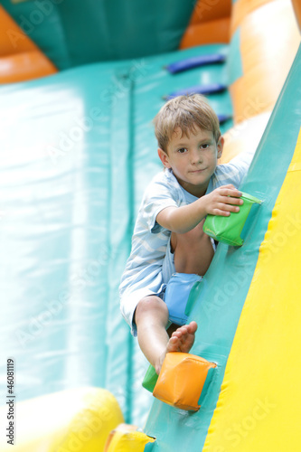Photo: young happy boy having fun on trampoline outdoors young happy boy having fun on trampoline outdoors