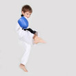 young boy kickboxing fighter in white kimono isolated on white