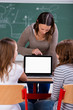 lehrerin erklärt etwas am laptop