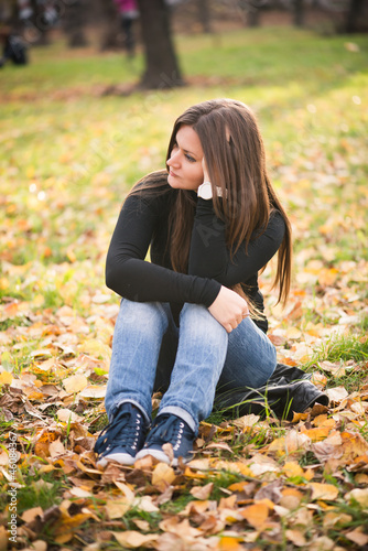 Photo: beautiful thoughtful girl in autumn park beautiful thoughtful girl in autumn park