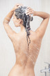 Young woman washing  head by shampoo