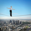 Balancing businesswoman and cityscape