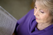 Mature older woman reading a book