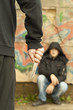 Boy looks at a man with a knife