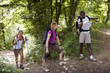 Photo: people with backpack doing trekking in wood people with backpack doing trekking in wood