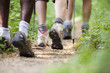 Photo: shoes of people trekking in wood and walking in row shoes of people trekking in wood and walking in row