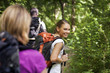 Photo: people with backpack doing trekking in wood people with backpack doing trekking in wood