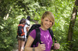 Photo: people with backpack doing trekking in wood people with backpack doing trekking in wood
