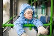 Photo: Adorable girl in blue jacket and hat ride on bus. Look to window Adorable girl in blue jacket and hat ride on bus. Look to window